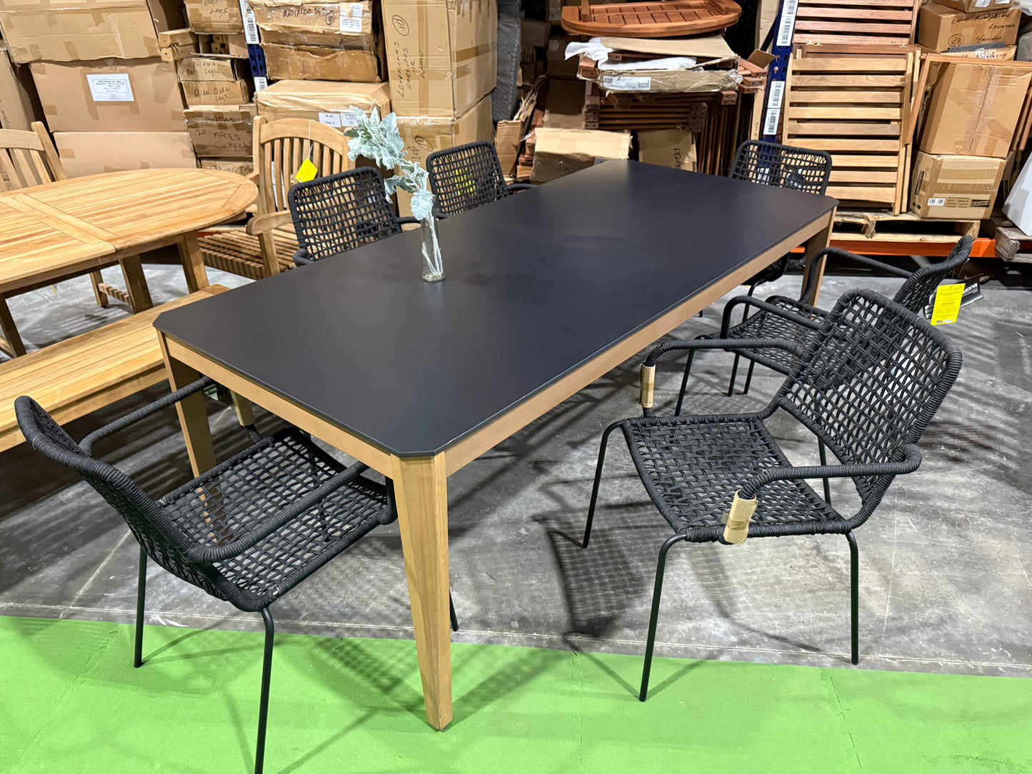 WAS $1099 NOW $549 BRAND BRAND NEW OPEN BOX OUTDOOR 85" WOOD AND RESIN TABLE WITH 6 STACKING BLACK ROPE CHAIRS