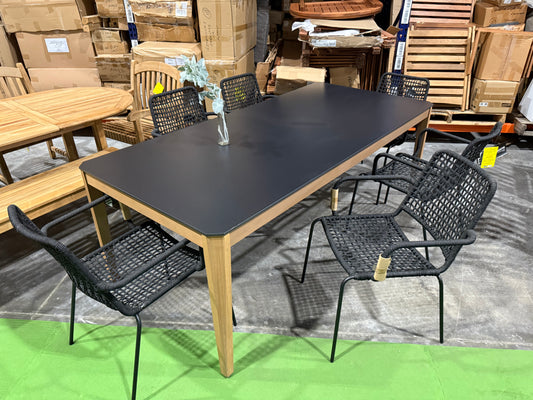 WAS $1099 NOW $549 BRAND BRAND NEW OPEN BOX OUTDOOR 85" WOOD AND RESIN TABLE WITH 6 STACKING BLACK ROPE CHAIRS