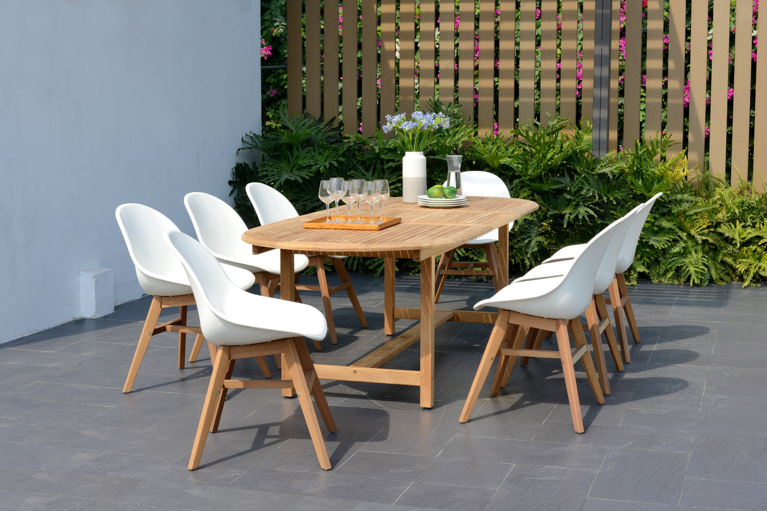 Outdoor dining set with wooden oval table and white chairs